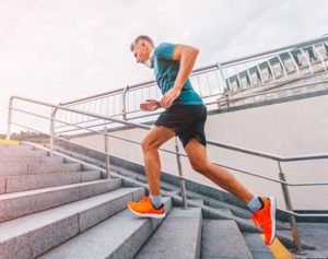Older man jogging up staircase