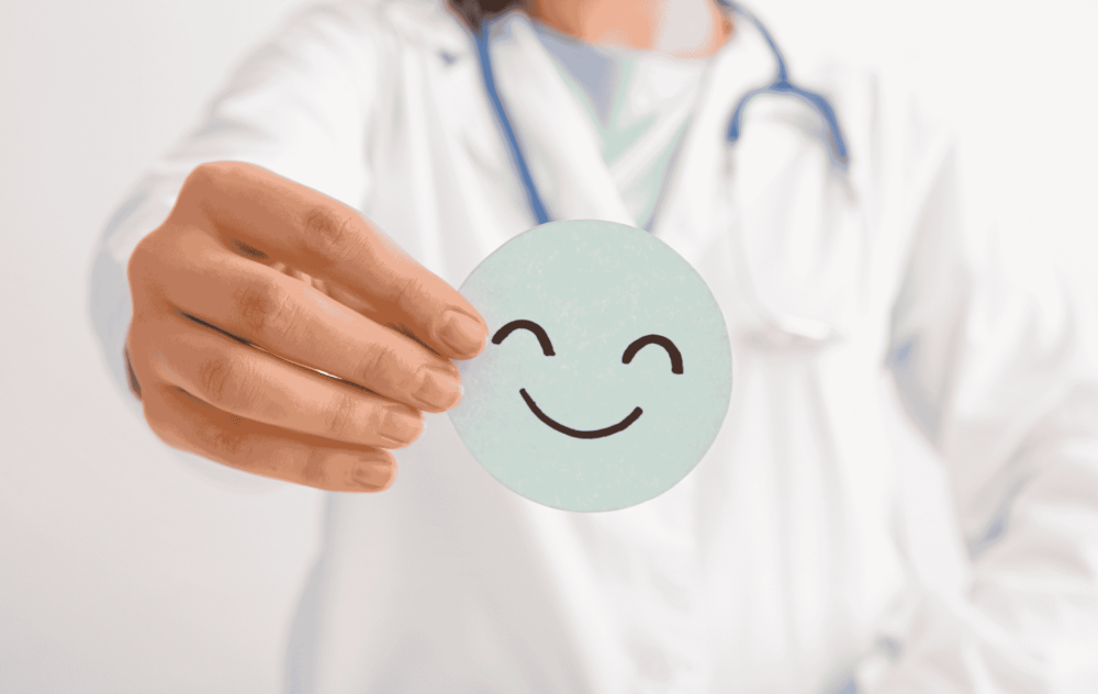 Doctor holding a happy face item